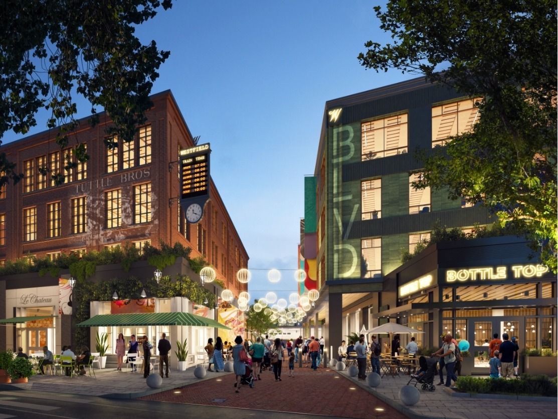 Street-level rendering of One Westfield Place: a pedestrian street lined with shops and cafés beside the train station