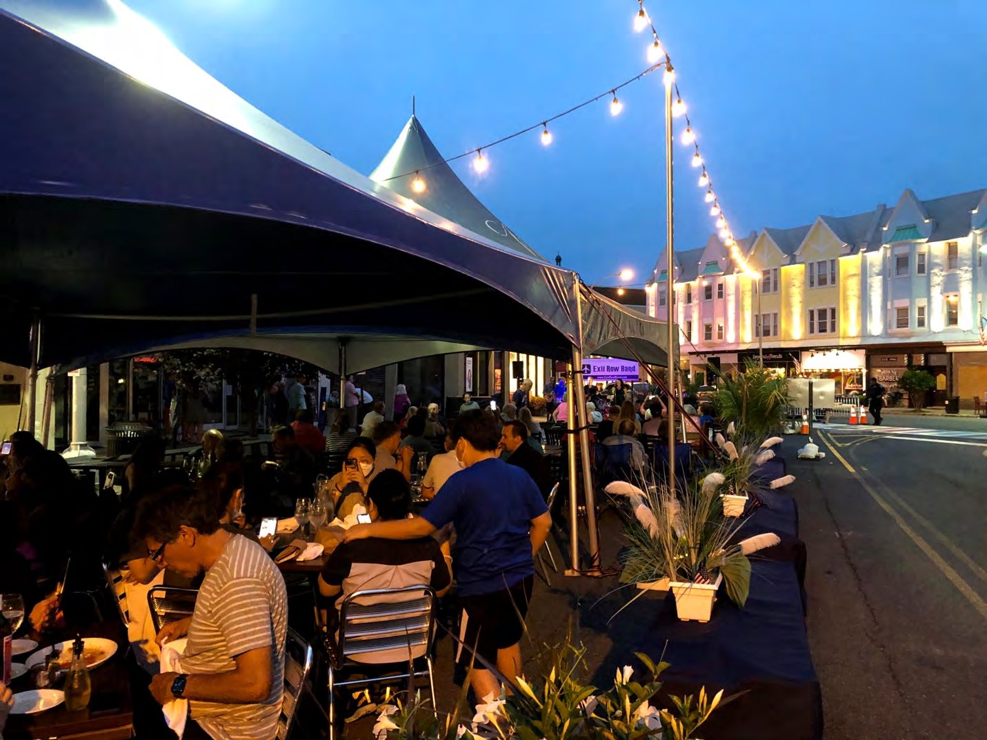 Outdoor dining tents and string lights on Quimby Street in downtown Westfield at dusk